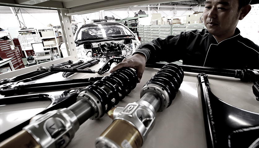 Suspension parts are arranged neatly on a work shelf after sub-assembly