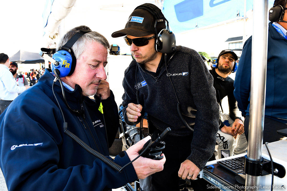 An engineer from TRD USA in conversation with team staff